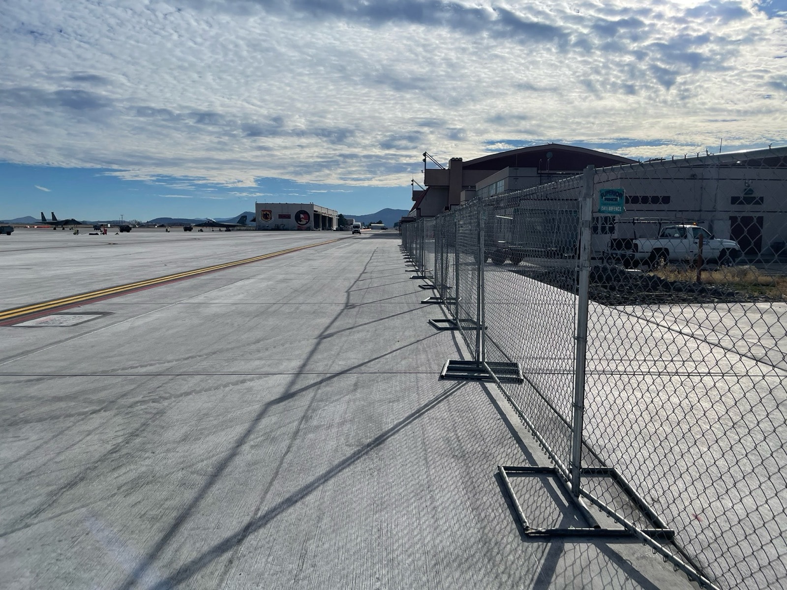 Temporary chain link fence lining an airport taxiway perimeter
